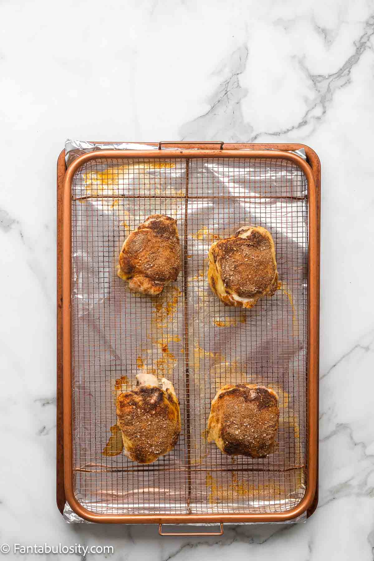 Seasoned chicken thighs roasted until the skin is golden and crisp, before the BBQ glaze goes on.