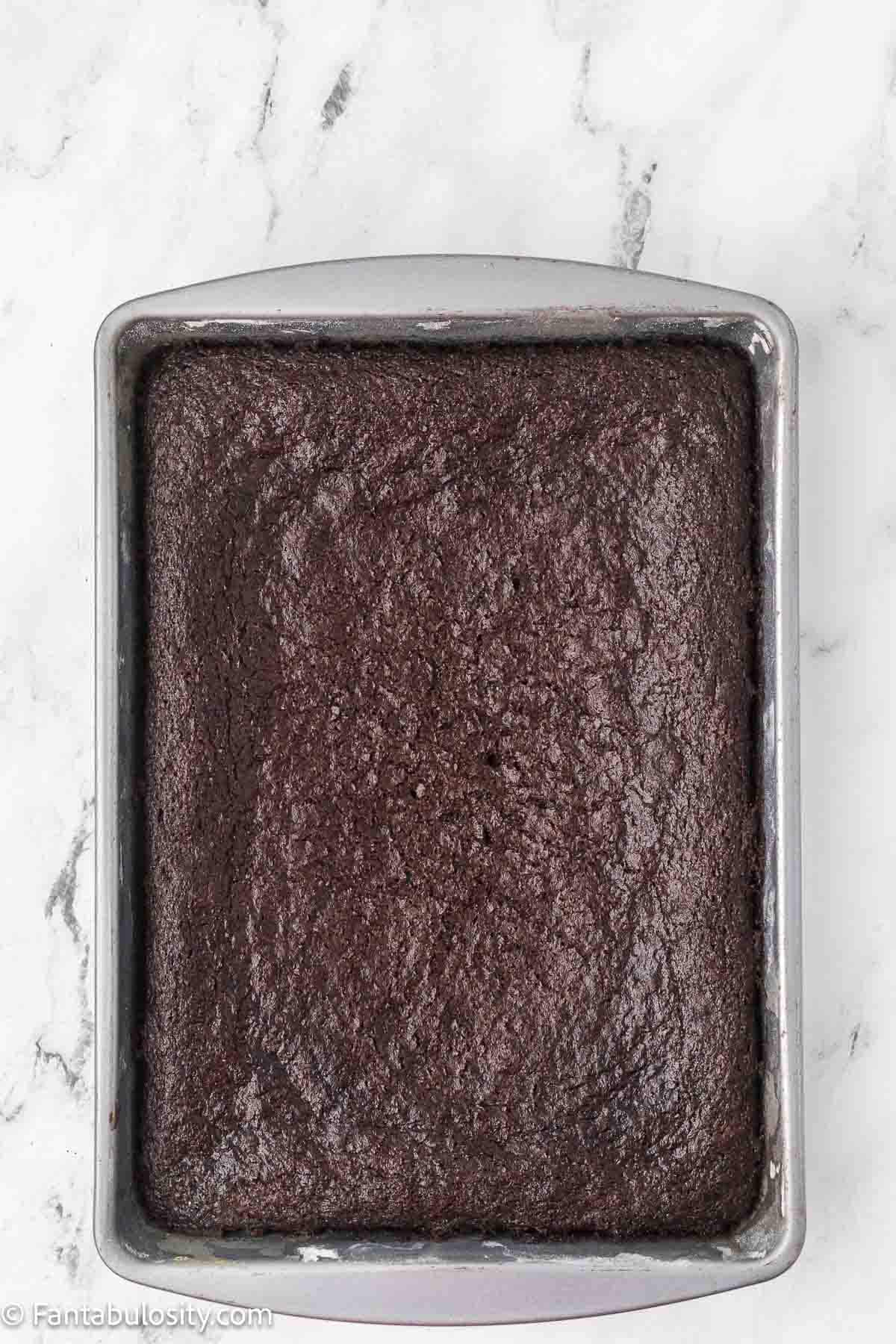 Baked chocolate mayonnaise cake cooling in its pan before frosting.