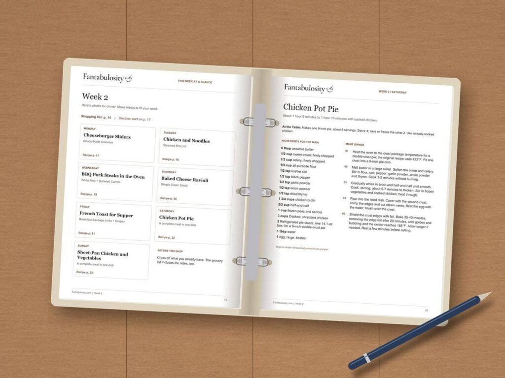 A Month of Dinners printed and open in a binder, showing the Week 2 menu and Chicken Pot Pie recipe