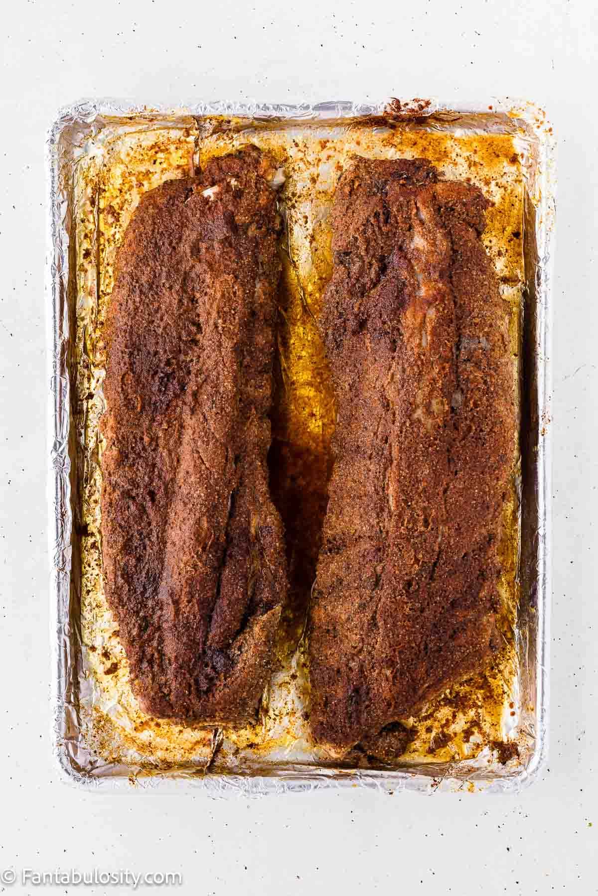Baby back ribs after baking covered at 275 degrees, with the rub set into a crust