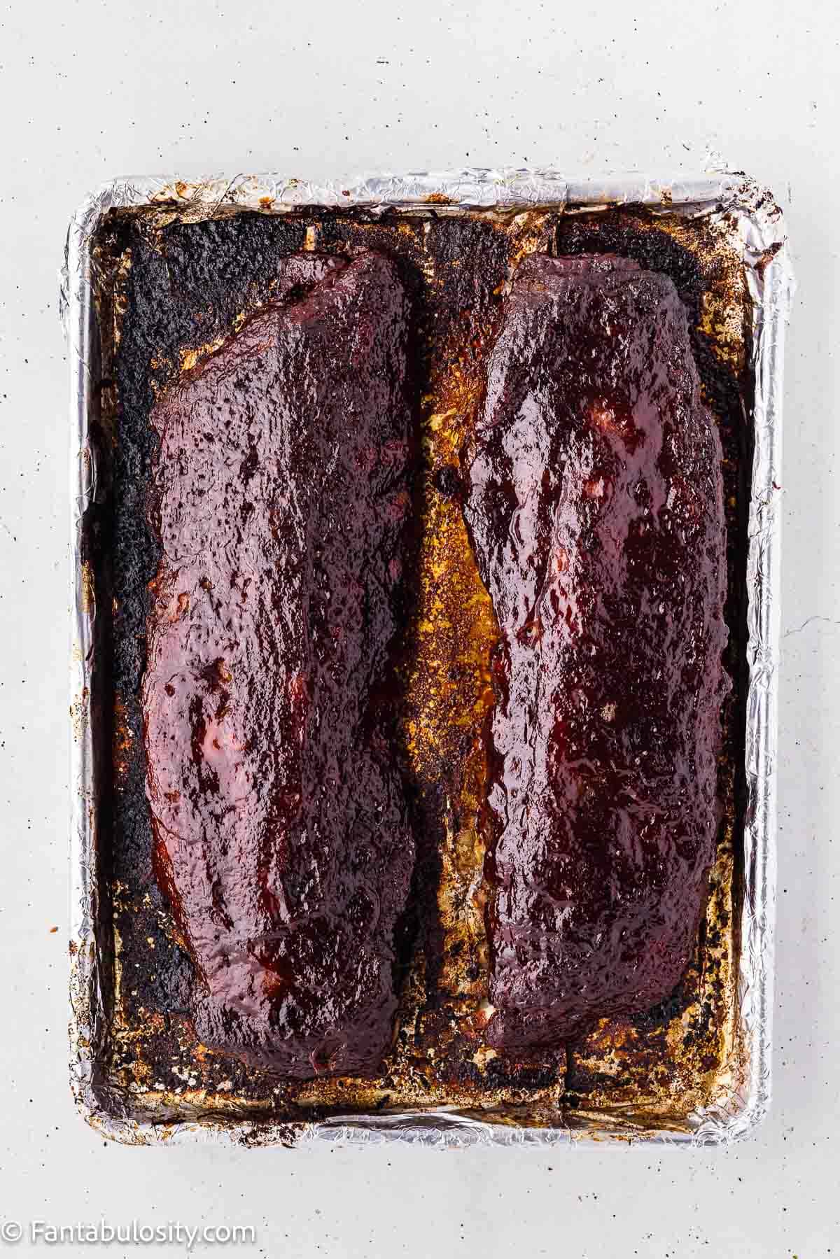 Oven baked ribs with a caramelized BBQ glaze after finishing at 400 degrees