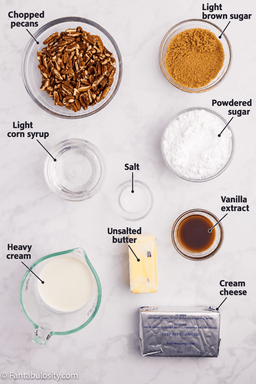 Labeled ingredients for pecan pie dip: chopped pecans, light brown sugar, powdered sugar, light corn syrup, salt, vanilla extract, heavy cream, unsalted butter, and cream cheese.