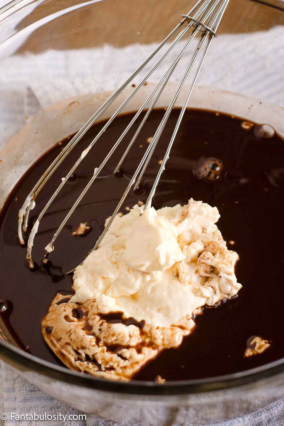 Mayonnaise being whisked into the cocoa mixture for chocolate mayonnaise cake batter.