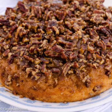 Pecan upside down cake topped with chopped pecans and brown sugar glaze