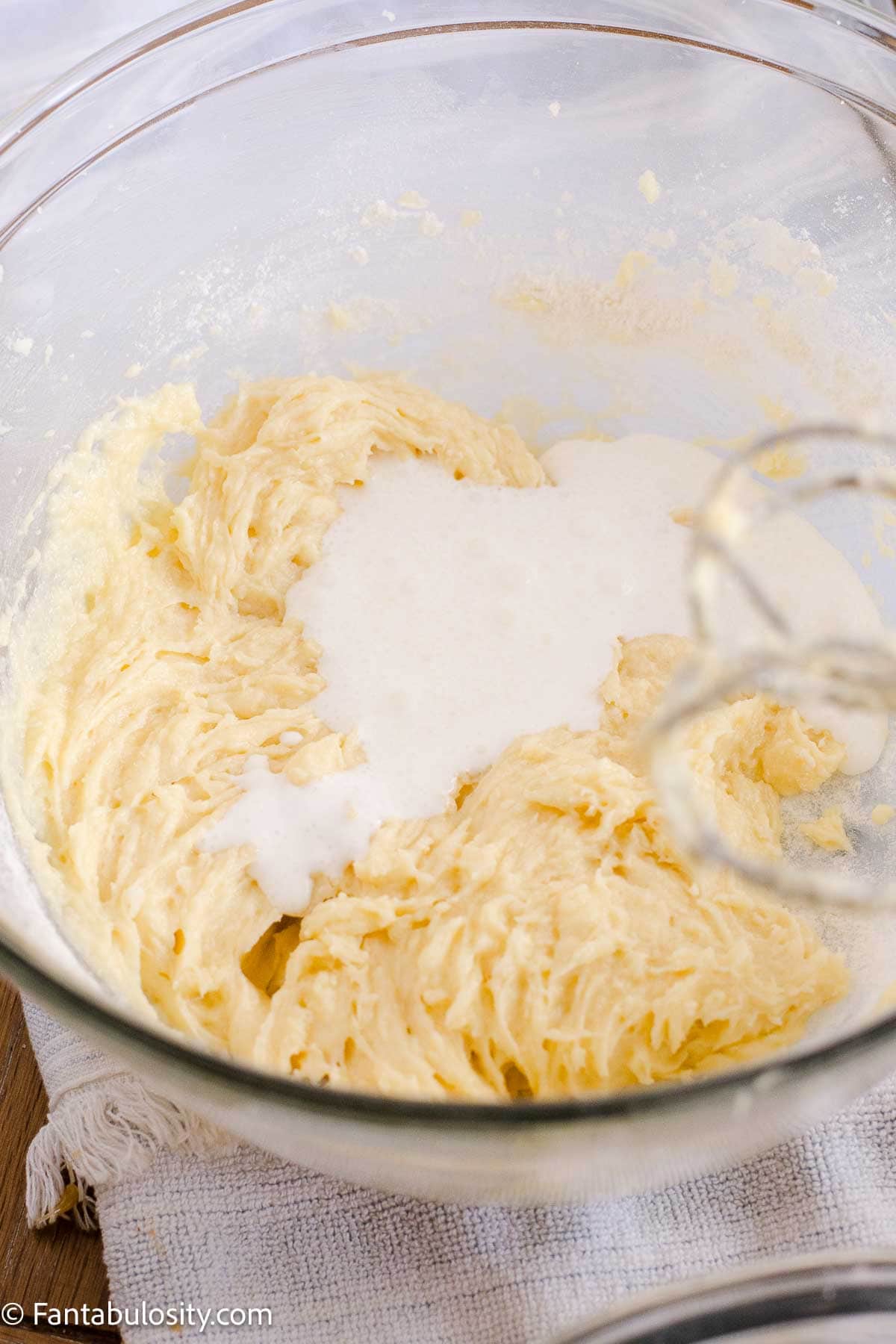 Sour cream mixture being added to the cake batter