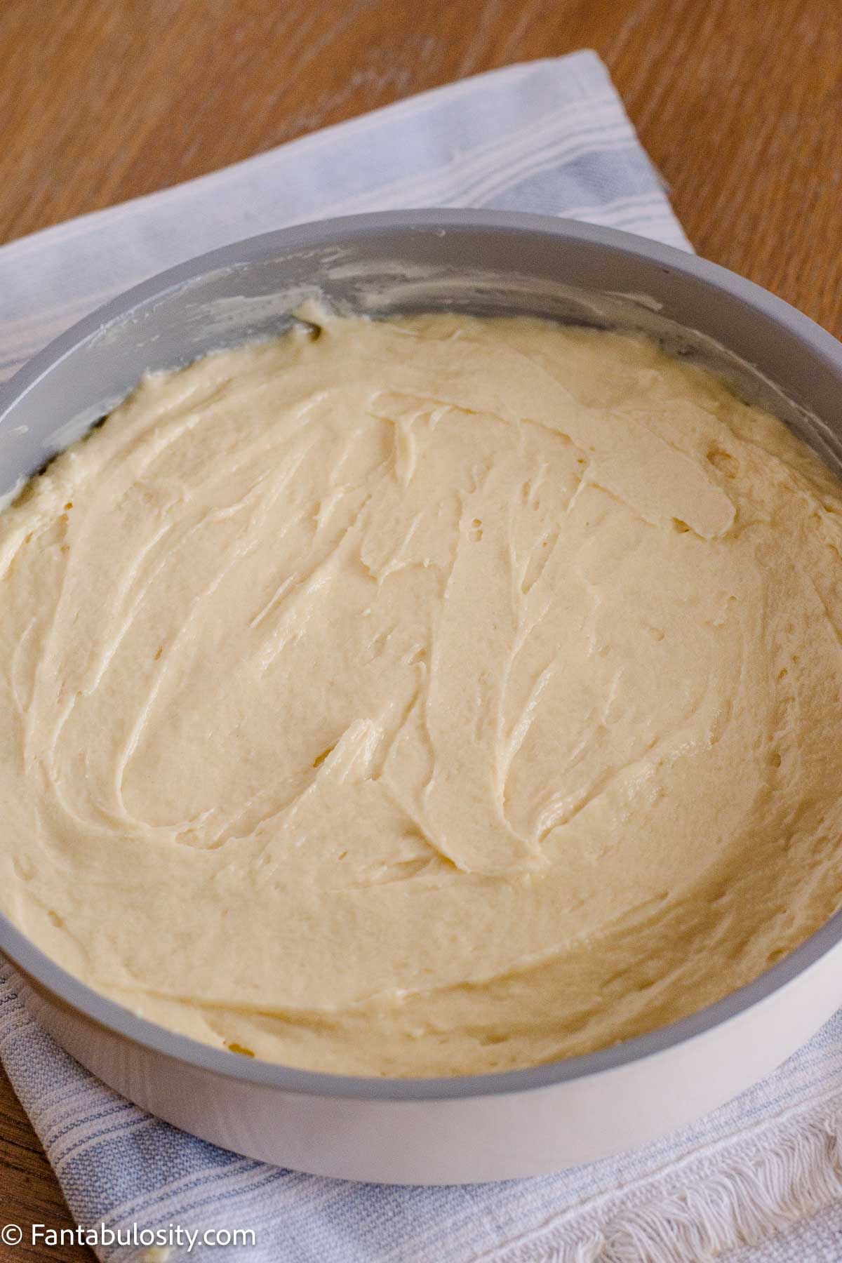 Cake batter spread evenly over the pecan topping