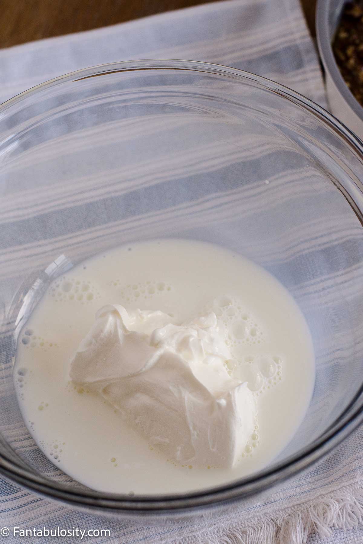 Sour cream and milk in a small glass bowl