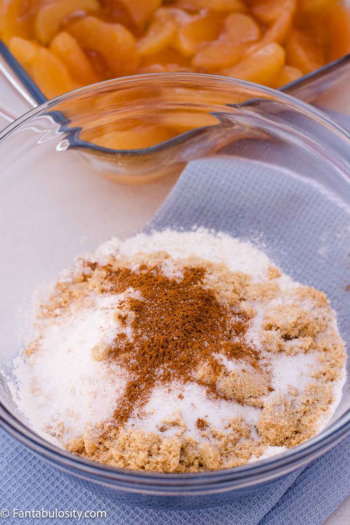Flour, brown sugar, granulated sugar, cinnamon, and salt in a glass mixing bowl.
