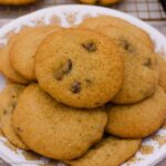 Grandma Ann’s chocolate chip cookies piled on a white plate with a gold floral pattern.