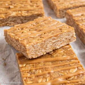 A close-up of peanut butter oatmeal bars with peanut butter drizzle.