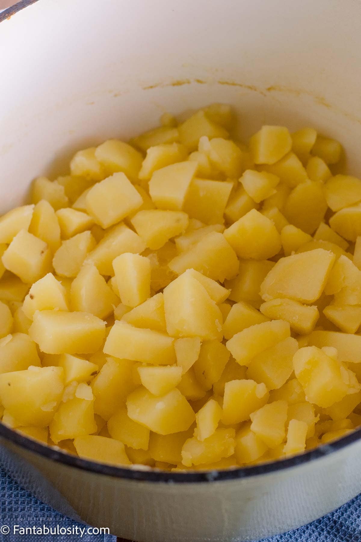 Tender potato chunks drained and returned to the pot.