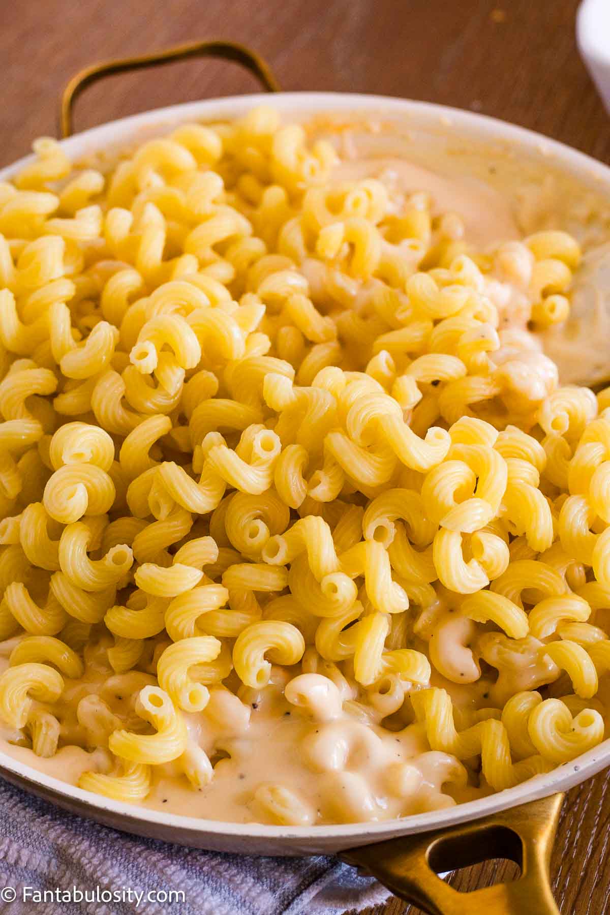Cooked cavatappi added to the creamy cheese sauce.