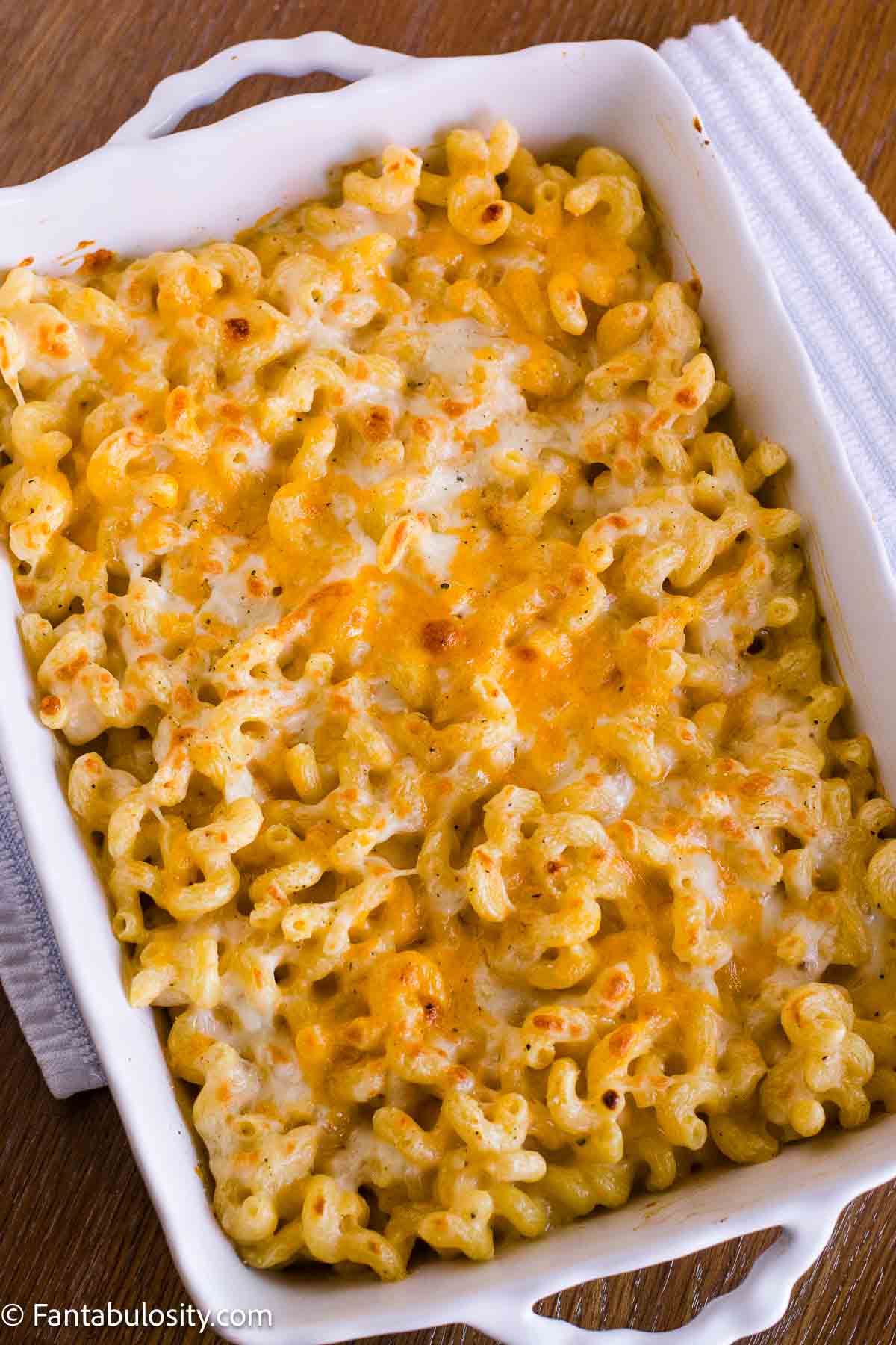 Sunday Best Mac and Cheese with a golden melted cheese topping in a white baking dish.